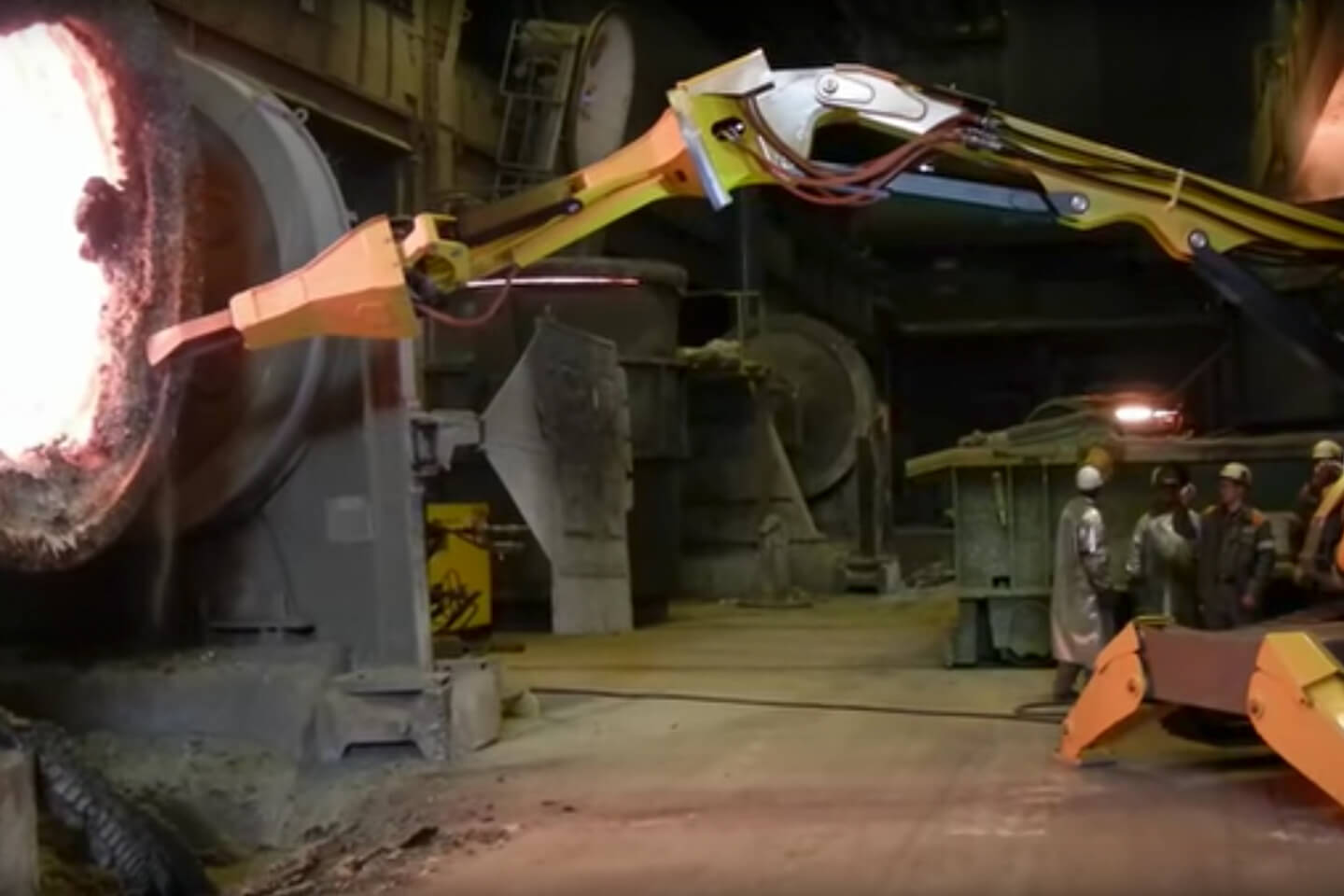 Brokk 800 demolition robot removing refractory from the mouth of a hot steel ladle.